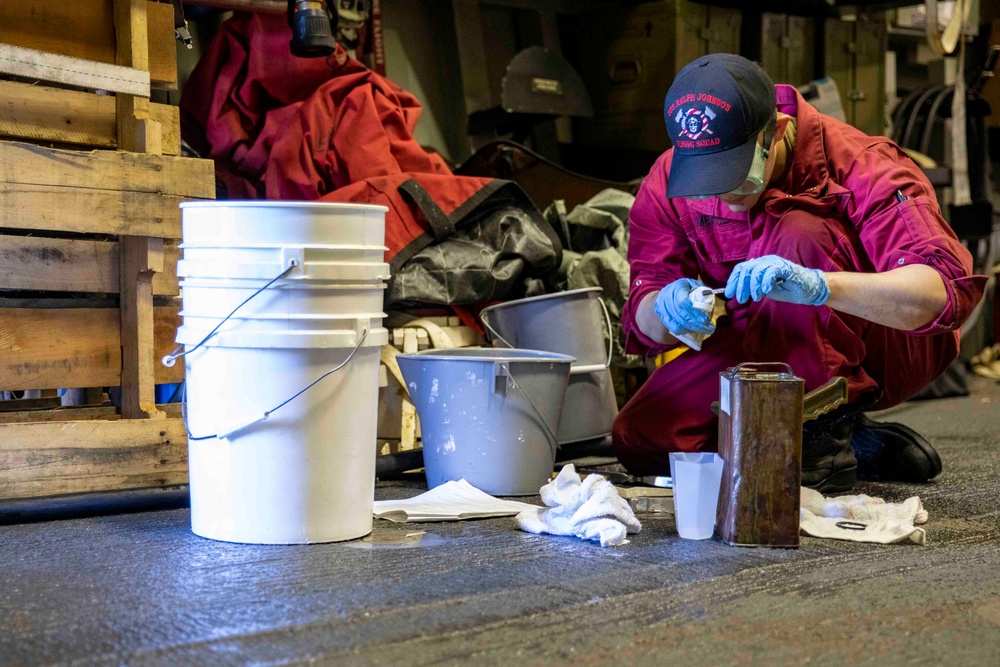 USS Ralph Johnson Sailor Conducts Maintenance