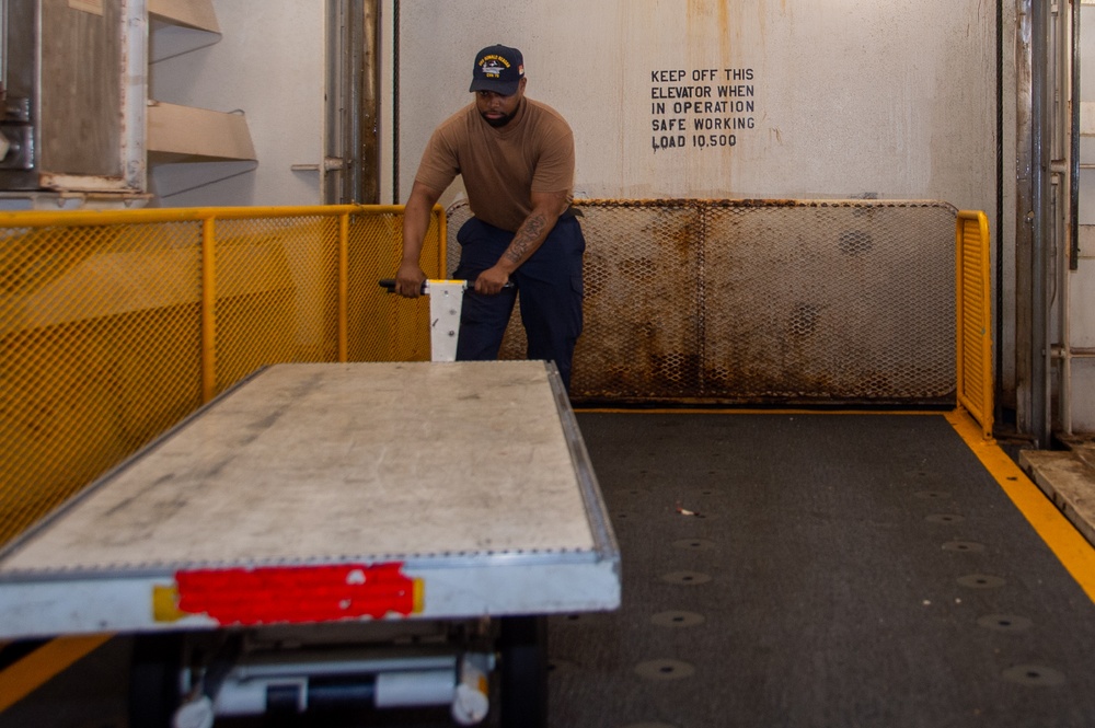 USS Ronald Reagan (CVN 76) Sailors transport sonar buoys