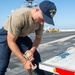 USS Ronald Reagan (CVN 76) Sailors transport sonar buoys