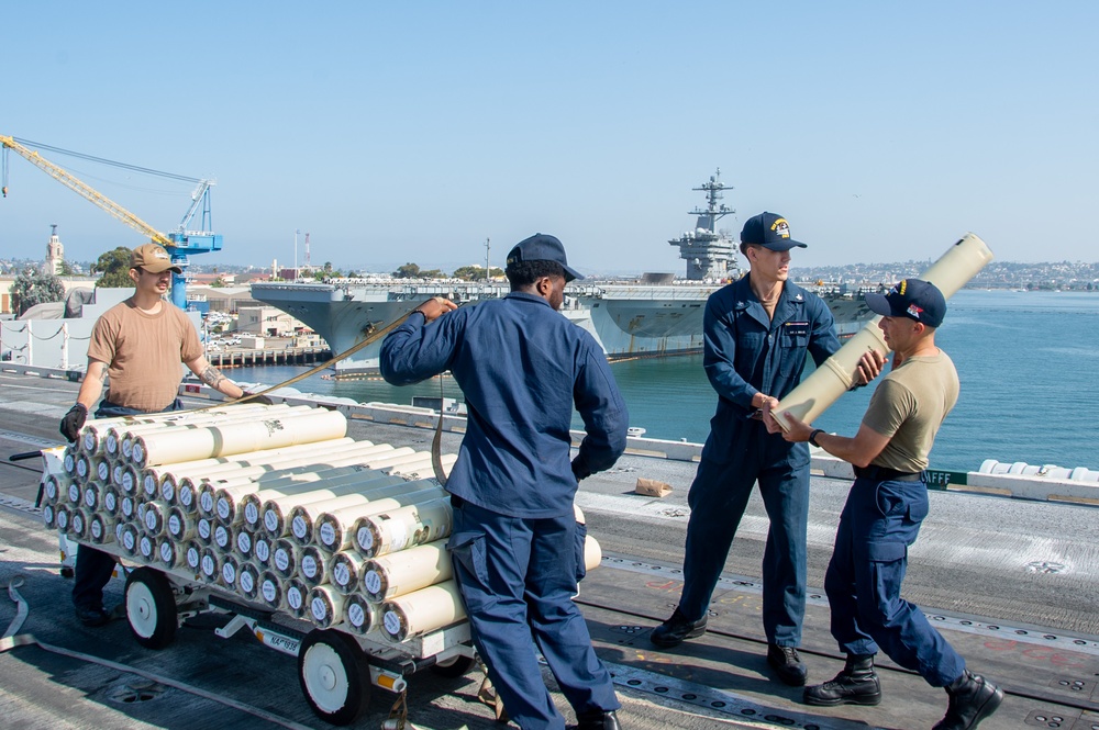 USS Ronald Reagan (CVN 76) Sailors transport sonar buoys