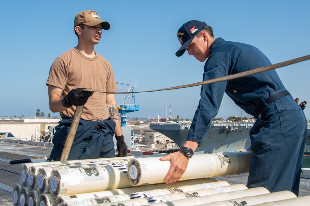 USS Ronald Reagan (CVN 76) Sailors transport sonar buoys