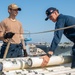 USS Ronald Reagan (CVN 76) Sailors transport sonar buoys
