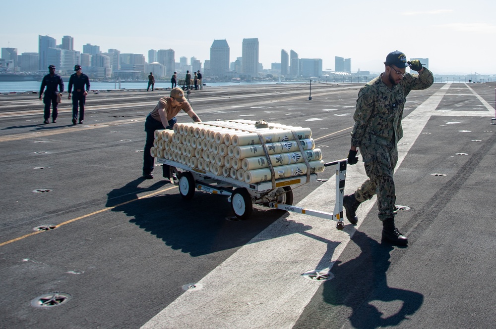 USS Ronald Reagan (CVN 76) Sailors transport sonar buoys