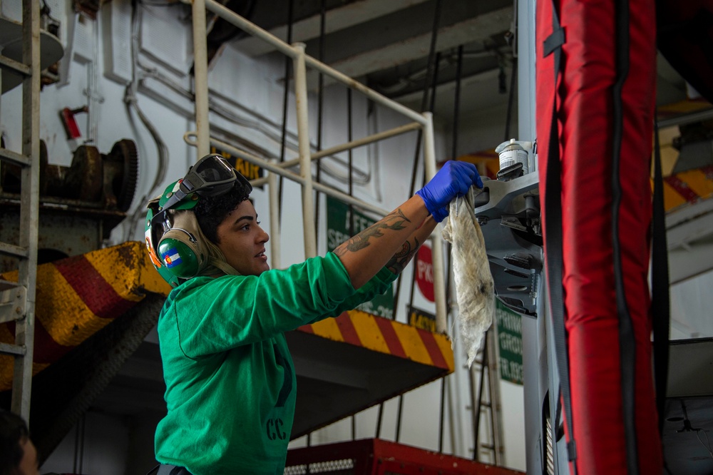 USS Carl Vinson (CVN 70) Aviation Structural Mechanic Cleans an Aileron Fairing on an F/A-18E Super Hornet