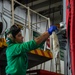 USS Carl Vinson (CVN 70) Aviation Structural Mechanic Cleans an Aileron Fairing on an F/A-18E Super Hornet