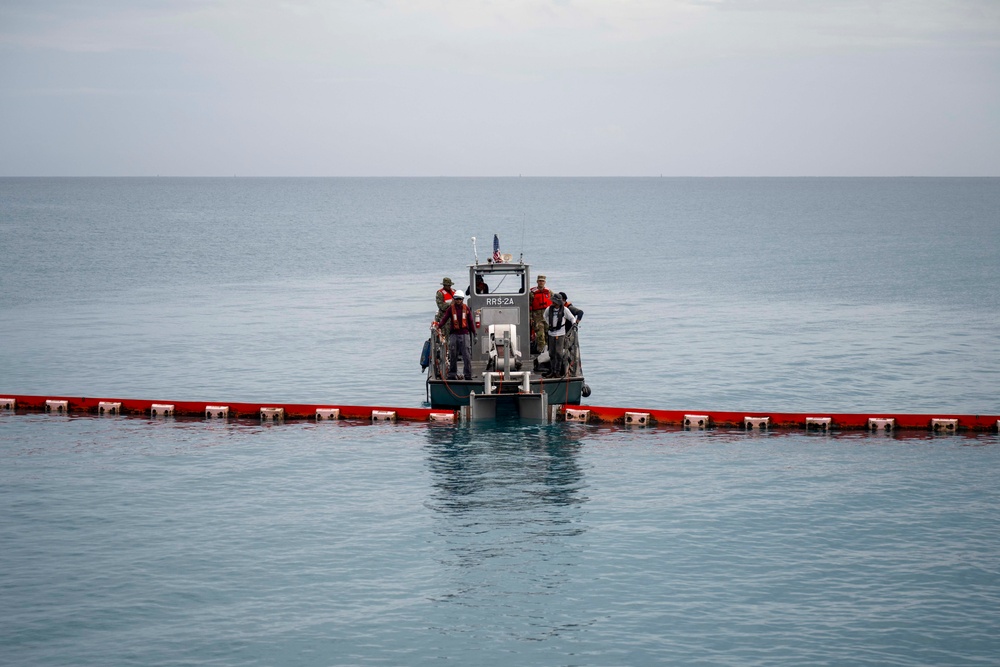 Sailors and Installation Personnel conduct an Oil Spill Simulation Drill
