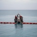 Sailors and Installation Personnel conduct an Oil Spill Simulation Drill