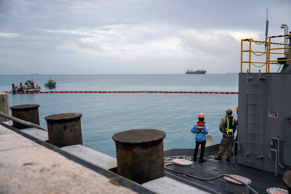 Sailors and Installation Personnel conduct an Oil Spill Simulation Drill