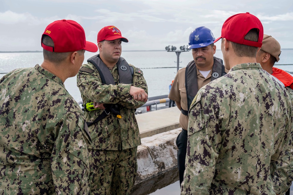 Sailors and Installation Personnel conduct an Oil Spill Simulation Drill