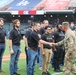 FCOE CG swears in recruits during baseball game