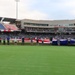 Volunteers hold American Flag during baseball game