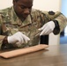 Army medic practices suturing