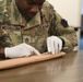 Army medic practices suturing