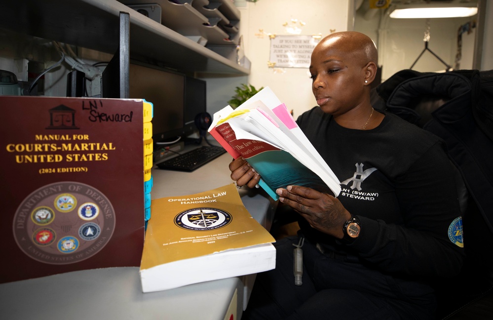 Carrier Strike Group Eight (CSG 8) Legalman Reads Legal References Aboard USS Harry S. Truman (CVN 75)