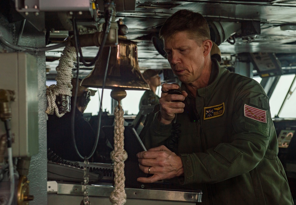 Rear Adm. Michael Wosje addresses the crew of USS Carl Vinson (CVN 70)