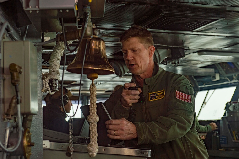 Rear Adm. Michael Wosje addresses the crew of USS Carl Vinson (CVN 70)