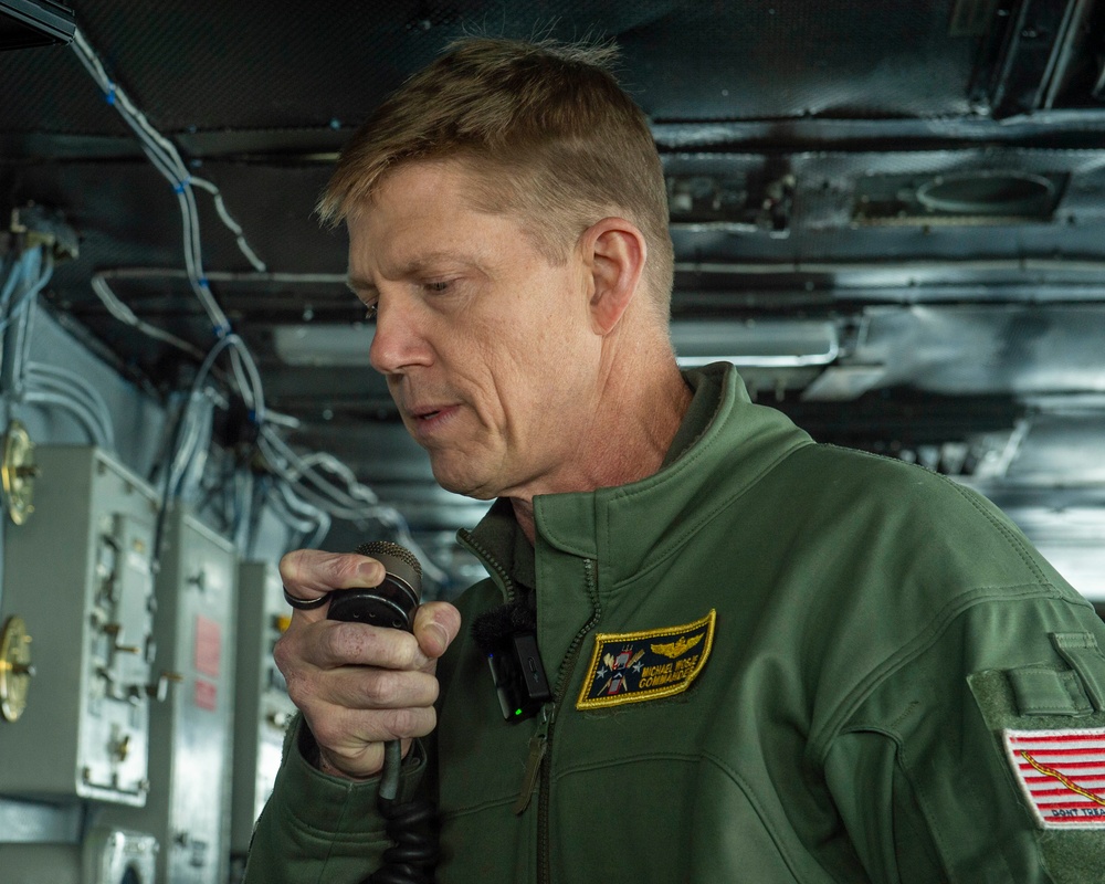 Rear Adm. Michael Wosje addresses the crew of USS Carl Vinson (CVN 70)