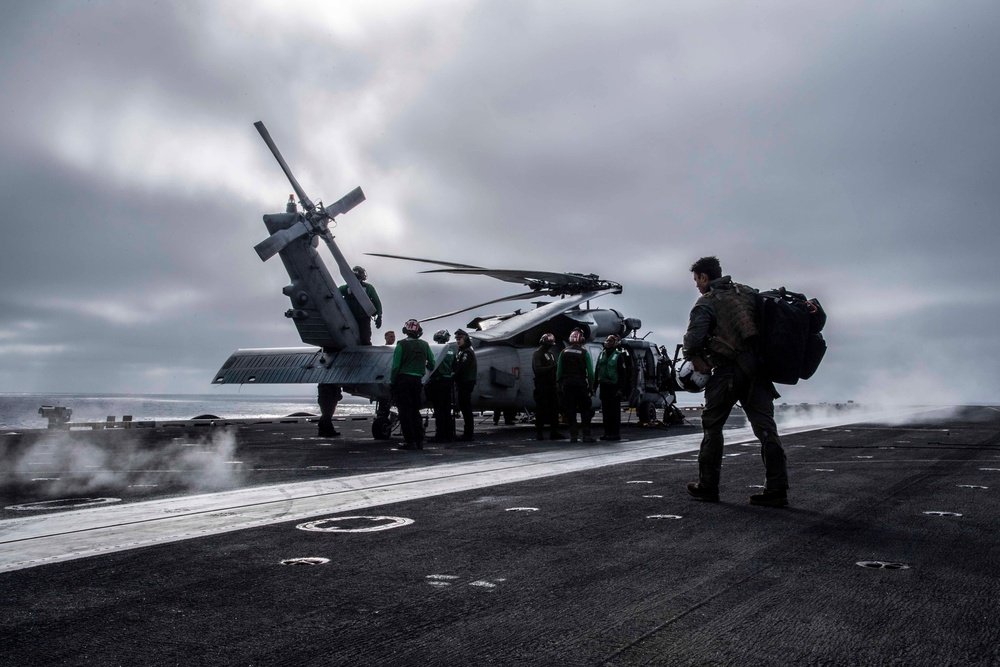 Sailors assigned to (HSC) 4 prepare for flight in an MH-60S Sea Hawk