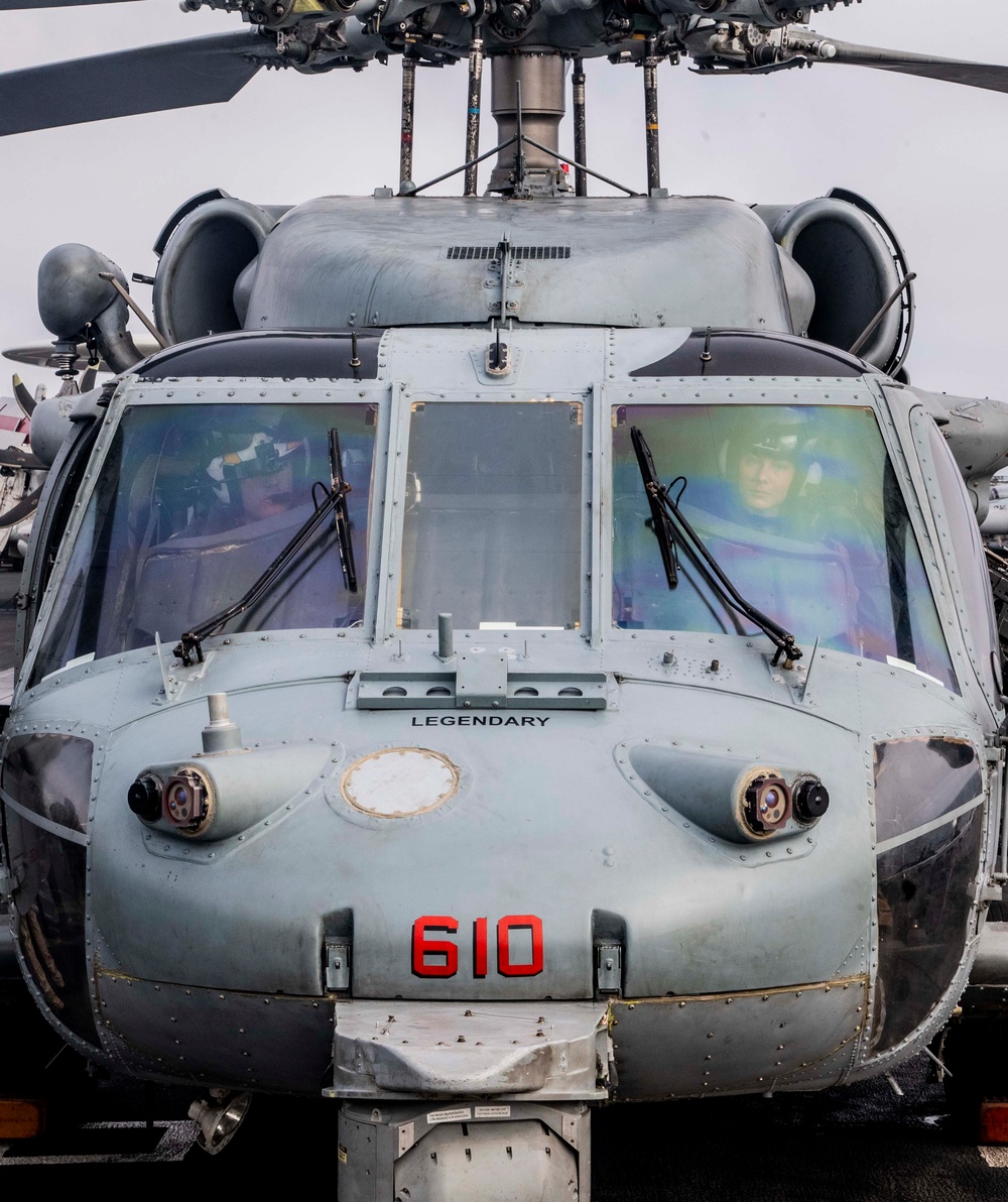 Sailors assigned to (HSC) 4 prepare for flight in an MH-60S Sea Hawk