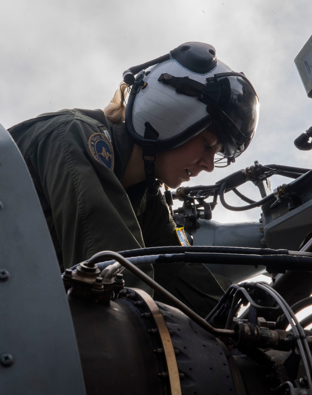 Sailors assigned to (HSC) 4 prepare for flight in an MH-60S Sea Hawk