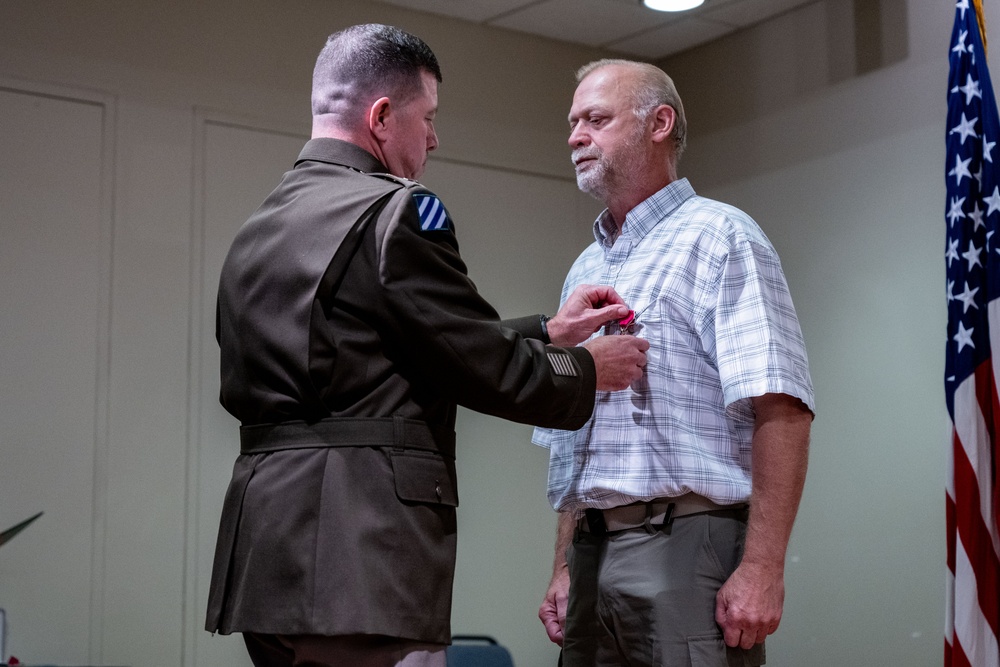 Wyoming Army Guard presents legion of merit to CW5 Doug Drost and John Fisher