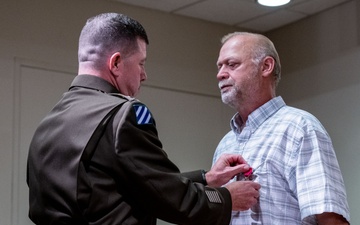 Wyoming Army Guard presents legion of merit to CW5 Doug Drost and John Fisher