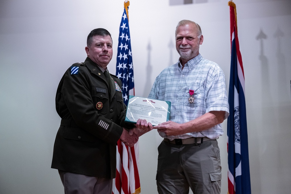 Wyoming Army Guard presents legion of merit to CW5 Doug Drost and John Fisher