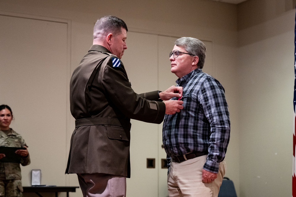 Wyoming Army Guard presents legion of merit to CW5 Doug Drost and John Fisher