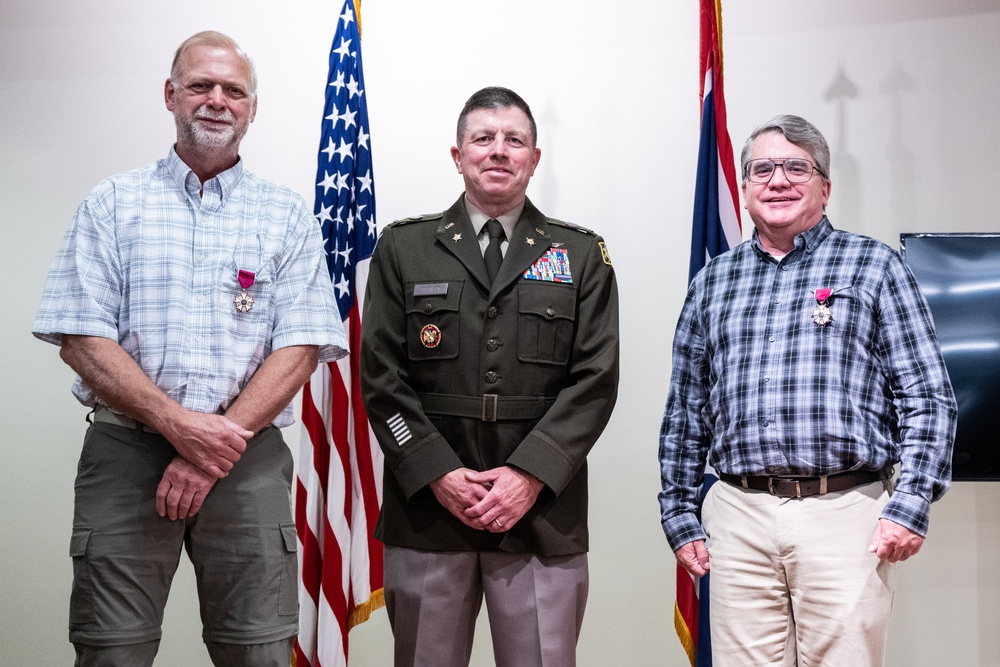 Wyoming Army Guard presents legion of merit to CW5 Doug Drost and John Fisher