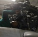 ATLANTIC OCEAN (Aug. 7, 2024) Aviation Machinist’s mate Airman William Laureano cleans and performs maintenance on a MH-60R helicopter in the hangar bay during Composite Training Unit Exercise (COMPTUEX)