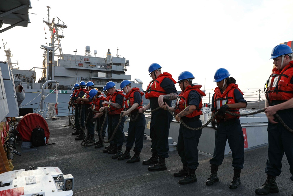 ATLANTIC OCEAN (Aug. 1, 2024) Sailors assigned to the Arleigh Burke-class guided-missile destroyer USS Jason Dunham (DDG 109), line handle during a replenishment-at-sea while underway for Composite Training Unit Exercise (COMPTUEX)