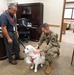 Maj. Gen. Larry Broadwell, 16th Air Force (AFCYBER) deputy commander, is introduced to 16th Air Force’s therapy dog “Bindi Lou.”