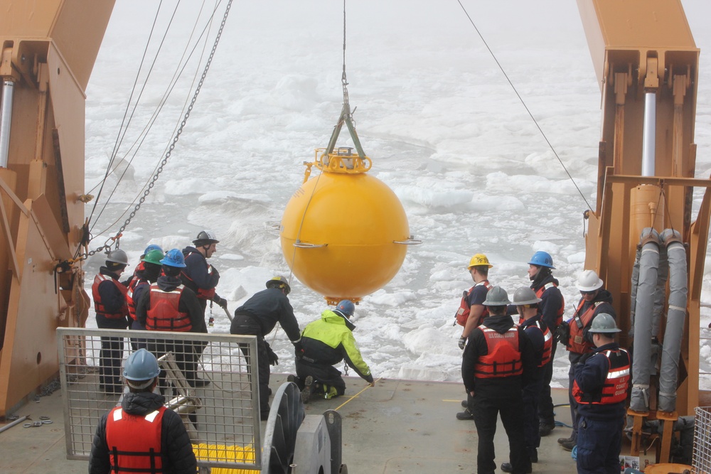 Members of the U.S. Coast Guard Cutter Healy (WAGB 20) deck department and the embarked science party aboard Healy deploy a subsurface mooring in the Beaufort Sea, July 16, 2024. This mooring is equipped with multiple sensors that collect oceanographic data pertaining to the physical, chemical, and biological properties of the Arctic Ocean. U.S. Coast Guard photo by Ensign Daniella Tipton.