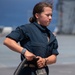 USS Tripoli Sailors spray and clean AFFF off of the Flight deck