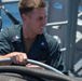 USS Tripoli Sailors spray and clean AFFF off of the Flight deck