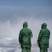 USS Tripoli Sailors spray and clean AFFF off of the Flight deck