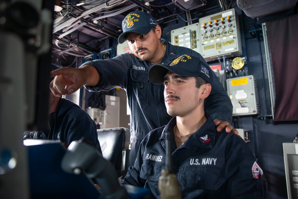 USS Spruance Sailors stand watch