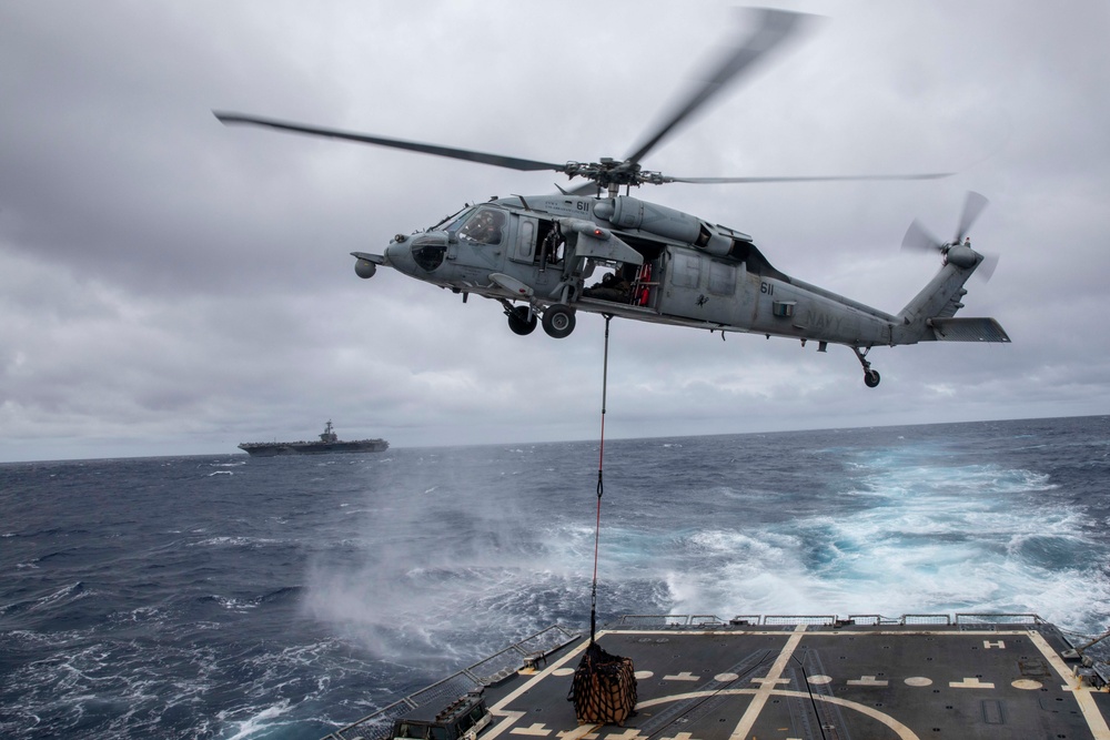 USS Spruance conducts vertical replenishment with USS Abraham Lincoln