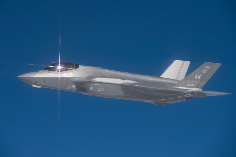 Alaska F-22s and F-35s refuel from a KC-46 during RF-A 24-3