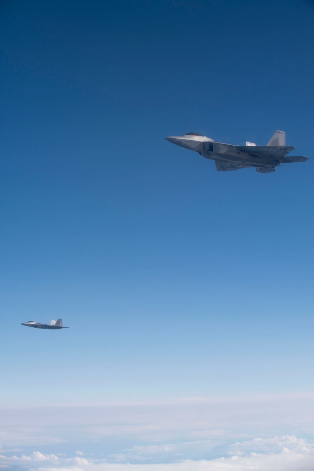 Alaska F-22s and F-35s refuel from a KC-46 during RF-A 24-3