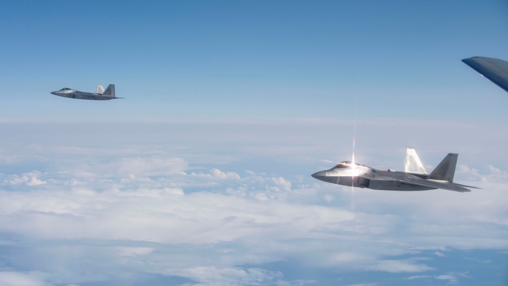 Alaska F-22s and F-35s refuel from a KC-46 during RF-A 24-3