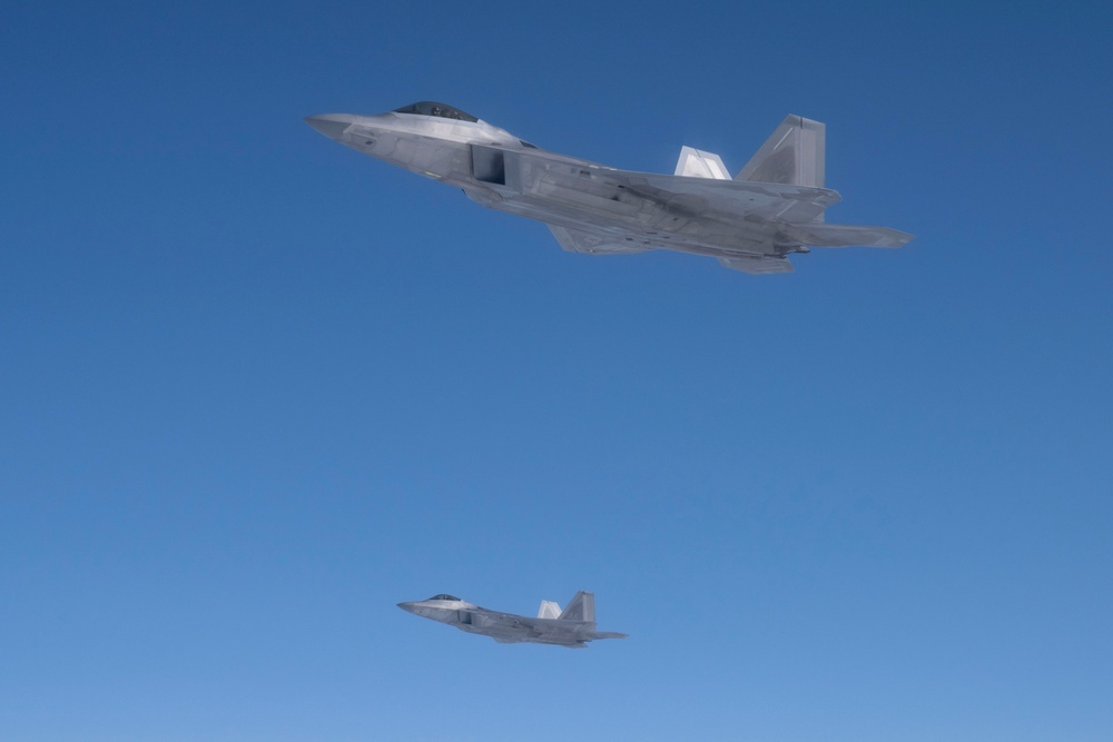 Alaska F-22s and F-35s refuel from a KC-46 during RF-A 24-3