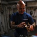 Coast Guard Cutter Northland crew members organize firearms in the armory