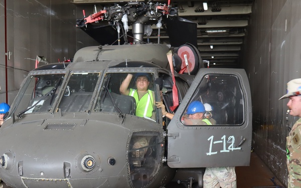 Soldiers assigned to the 1st Infantry Division Combat Aviation Brigade (CAB) unload their aircraft from aboard a commercial cargo vessel at the Port of Corpus Christi, Texas, Aug. 13.