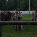 Marines with Marine Corps Combat Service Support Schools maneuver through an obstacle course