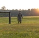 Marines with Marine Corps Combat Service Support Schools maneuver through an obstacle course