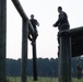 Marines with Marine Corps Combat Service Support Schools maneuver through an obstacle course