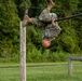 Marines with Marine Corps Combat Service Support Schools maneuver through an obstacle course