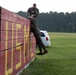 Marines with Marine Corps Combat Service Support Schools maneuver through an obstacle course