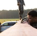 Marines with Marine Corps Combat Service Support Schools maneuver through an obstacle course